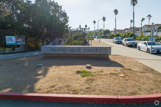 School Sign entrance area with some outside parking.