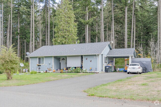 A common traditional home in Nisqually Indian Community with heavy tree coverage.