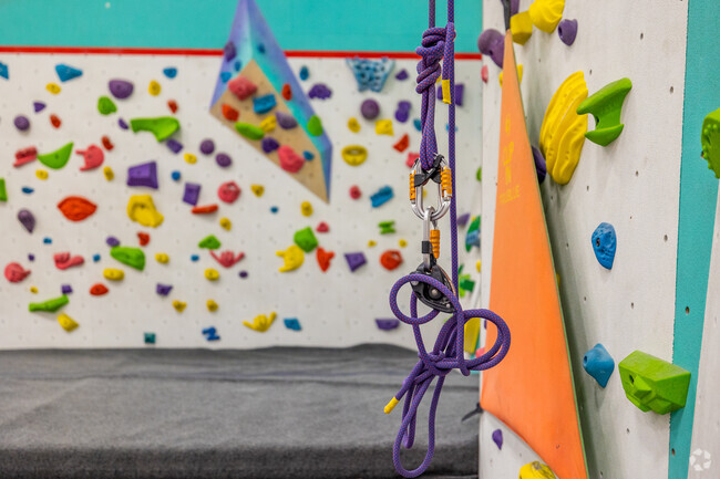 A rope hangs from a climbing wall at the Zenith Climbing Center