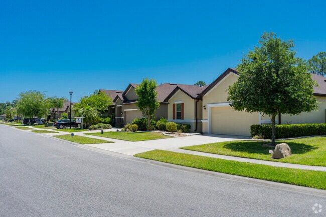 This row of homes in Tuscany Woods has neatly manicured lawns and neighborhood sidewalks.