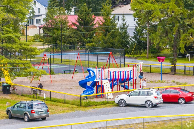 A playground attracts local families to Deer Lake Grove Park.