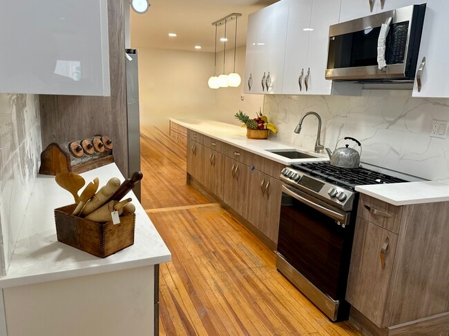 Newly renovated kitchen, stainless steel appliances, original wooden floor. generous storage