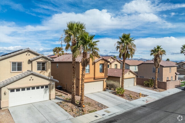 Most homes in Centennial Hills Town Center have attached garages and desert landscaping.