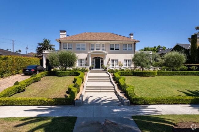 A grand European-style home in Windsor Square features a spacious walkway leading up to it.