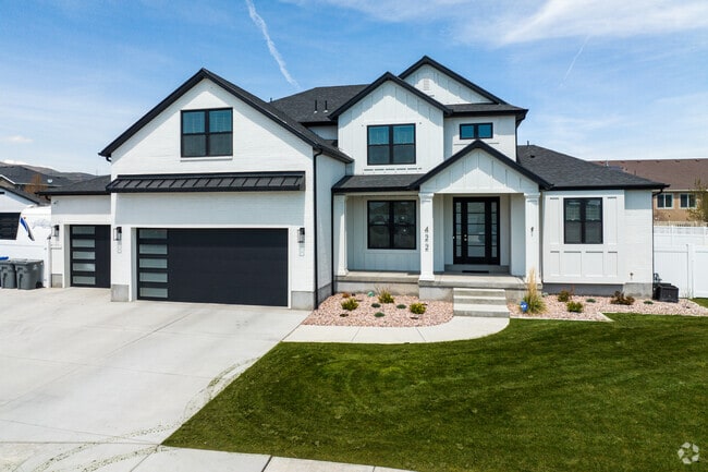 The white vinyl home in Saratoga Springs is a charming single-story home with a well-manicured front yard featuring a classic design.