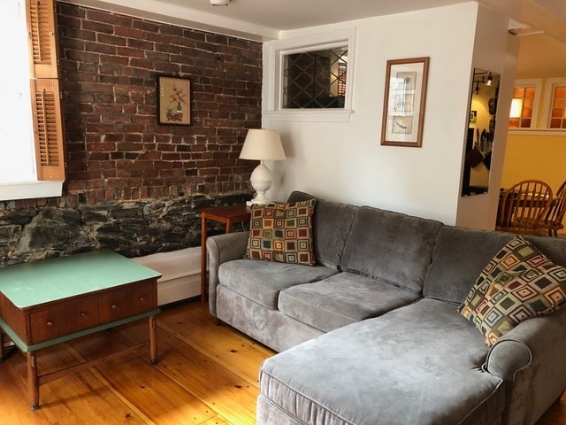 Wood floors, exposed brick, sectional couch