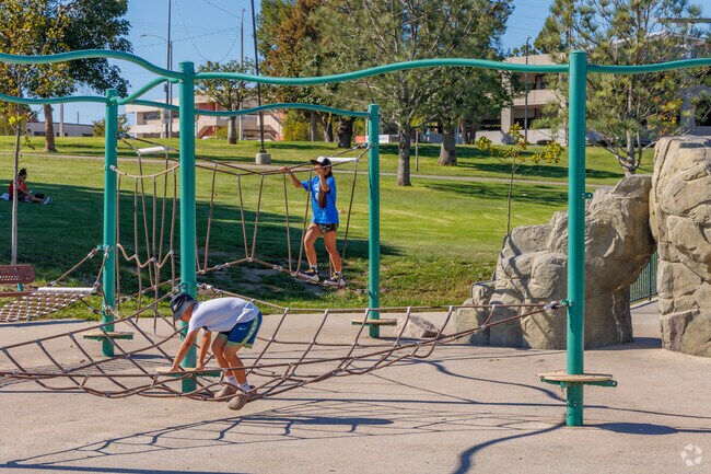 Children’s playground at Ken Malloy Park offers shaded seating and colorful climbing structures.