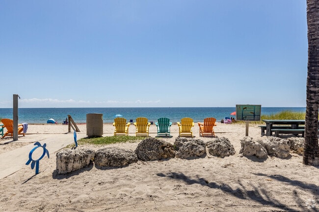 Colorful beach chairs and sculptures invite residents of Dolphin Isles to the beach.