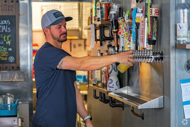 Friendly bartender at CJ's Bar and Grill pours IPA for regular in Stanford Ranch.