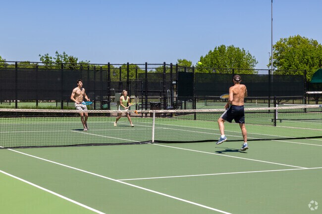 Locals play a game of tennis at Leawood City Park.