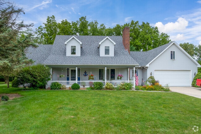 Colonial Revival-style home in Hicksville showcases a flower-adorned front porch.
