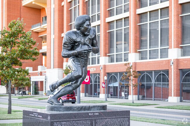 Many statues of OU football players adorn the lawn at the University of Oklahoma stadium.