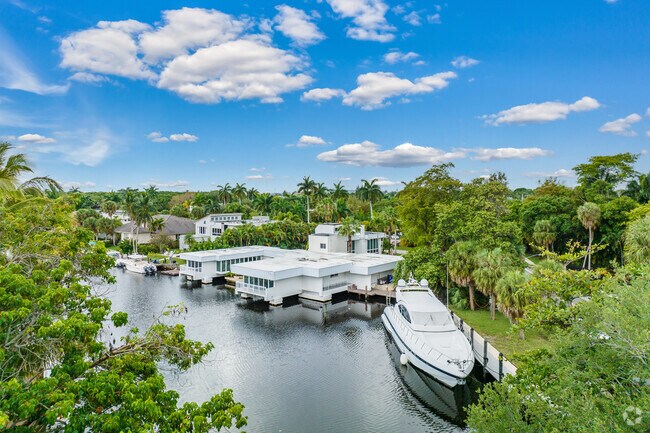 Contemporary waterfront property with a docked yacht in the River Run neighborhood.