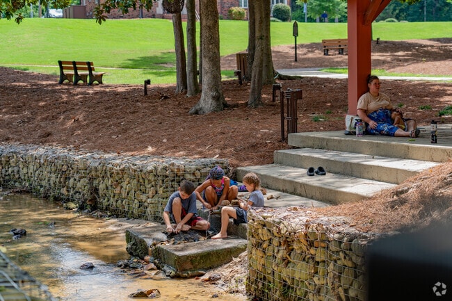 Fuquay-Varina residents relax and frolic in the waters at Fuquay Mineral Spring Park.