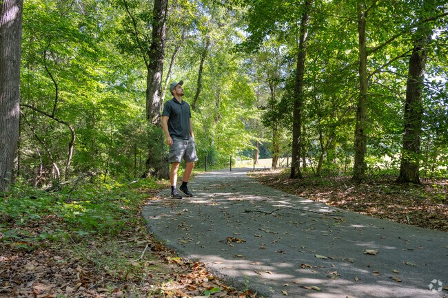 Locals enjoy taking a morning stroll on the paved trails at Charlie Lollis Memorial Park.