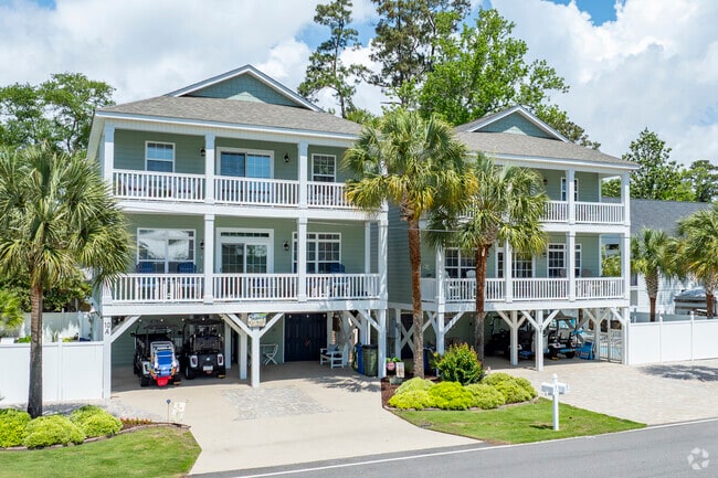 Stilted beach homes in Surfside Beach showcase coastal resilience and offer stunning views, blending charm with practicality.