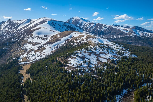 Blue Lakes Trail in Blue River, Colorado, offers a breathtaking alpine hike starting above 11,700 feet. This moderate trail winds past shimmering lakes, waterfalls, and historic mining relics, with panoramic views of towering peaks like Quandary Peak.