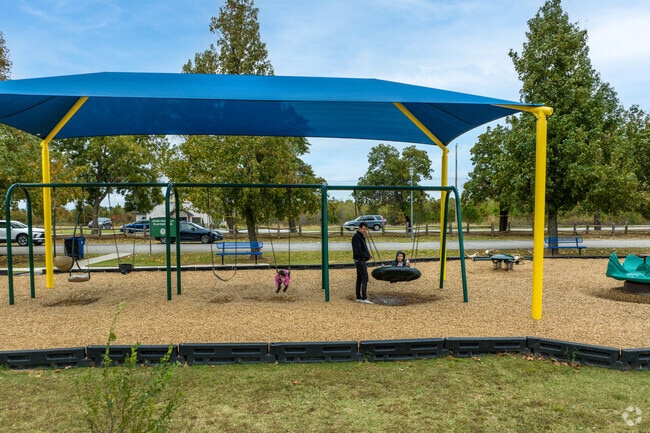 Families enjoy the playground at Choctaw Creek Park.