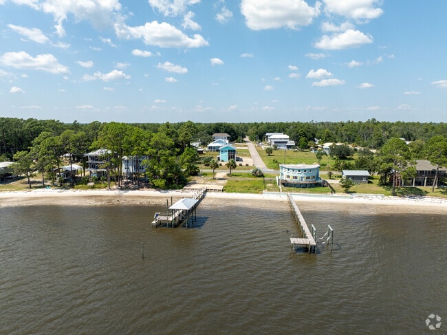 Elevated coastal homes line the serene waterfront of Florida’s Forgotten Coast in Lanark Village.