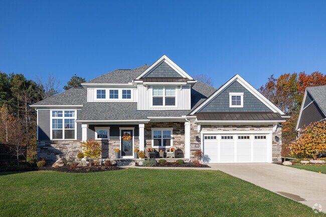 A modern home with lush green grass and stunning landscaping in the Richfield area.