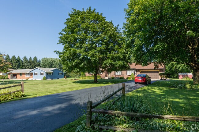 Pair of brick and blue siding ranch homes with long driveways, Deep Run, Merrillville, IN.