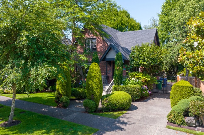 A Tudor home on McGilvra Blvd in E Madison Park is tucked away behind trees.