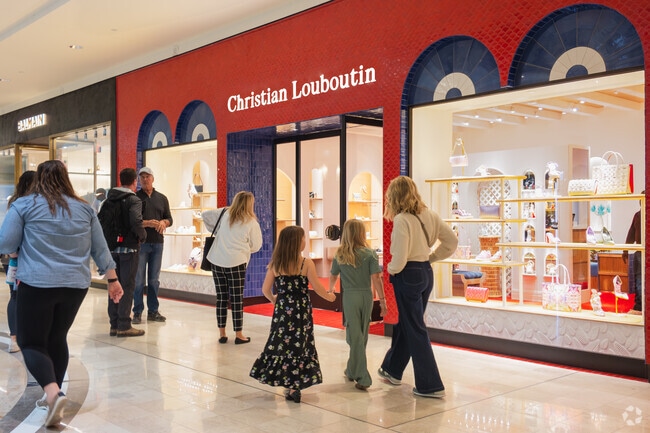 Upscale boutiques, like Louboutin, dazzle with illuminated storefronts at Phipps Plaza - minutes from Peachtree Corridor.