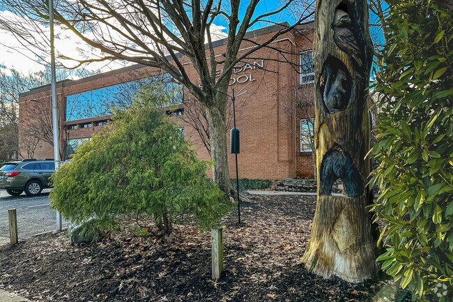 Wood art sculpture in front of Sheridan School