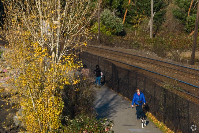 A paved walking trail runs beside the train track at Titlow Beach.