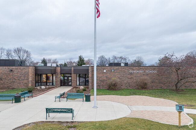 Benches and a Little Library greet students on their way into Coventry Elementary School.