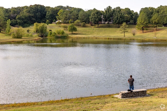Enjoy a serene day as a man casts his line into the waters of the community lake in Brookwood.