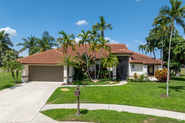 Homes in The Lakes at Boca Raton are spacious on large lots with driveways and front yards.