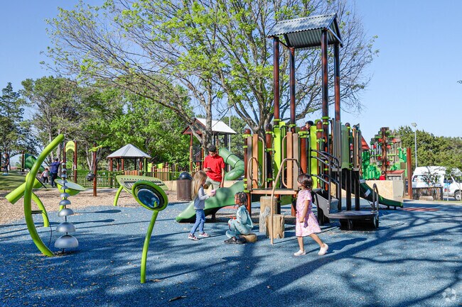 Local children enjoying running and playing at DeBusk Playground on sunny days.