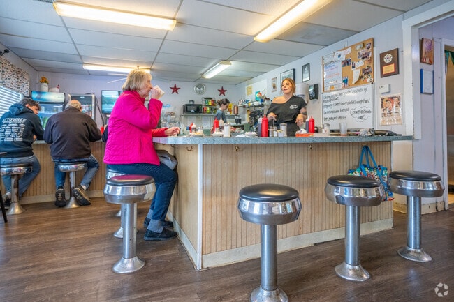The diner-style interior of The English Muffin features a welcoming counter and casual seating where guests enjoy hearty meals.