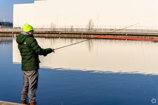A man practices his fly fishing casting strokes at the Moores Park Dam.