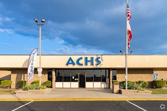 An American flag waves at the entrance to Accelerated Charter High School.