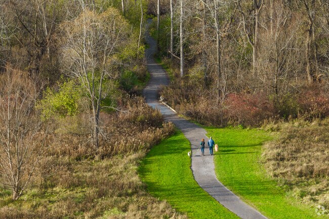 A couple walk their dogs along one of many trails in Getzville, New York.