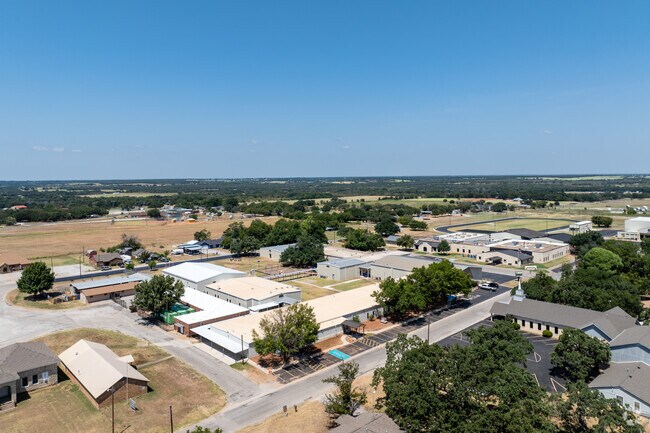 Lipan High School showcases its expansive campus surrounded by peaceful, rural landscapes.