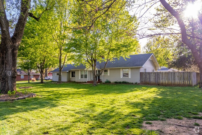 A large ranch home is shaded by large trees in the Seminole/Holland neighborhood.
