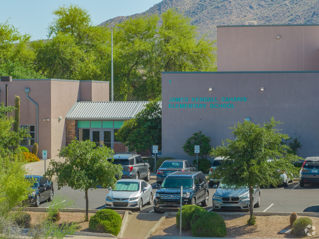 Zaharis Elementary School main entrance with some trees in the parking lot.
