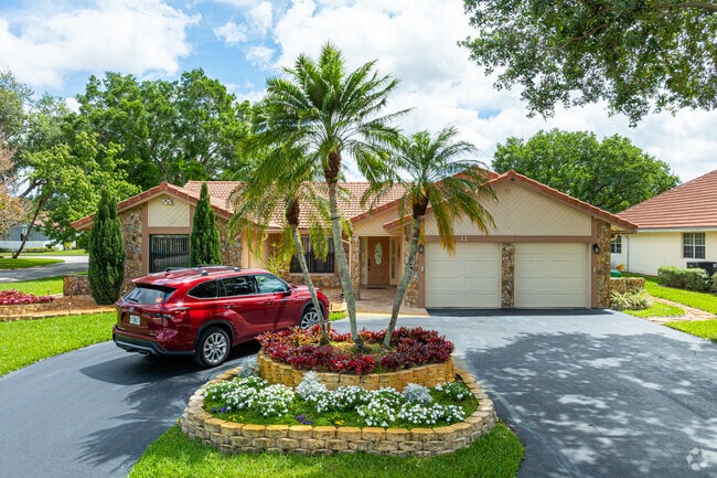 The homes in Cypress Glen offer a variety of designs, like stone facades and gable roofs.