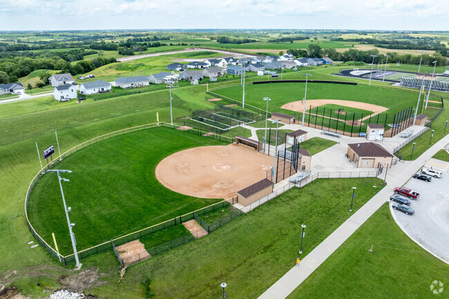 The adjacent fields include softball and baseball fields.
