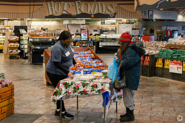 North End Supermarket giving out bakery samples to residents.