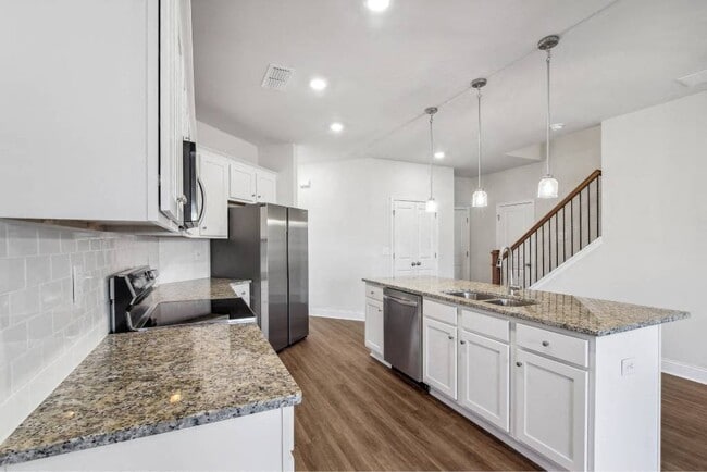 A view of the spacious kitchen and stainless steel appliances