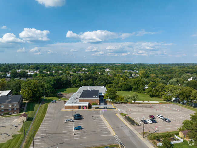 Aerial view of school campus with neighborhood on the horizon.