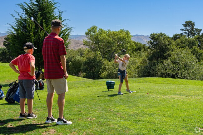 A young golfer plays a round with her dad at Laguna Lake Golf Course in Billygoat Acres.