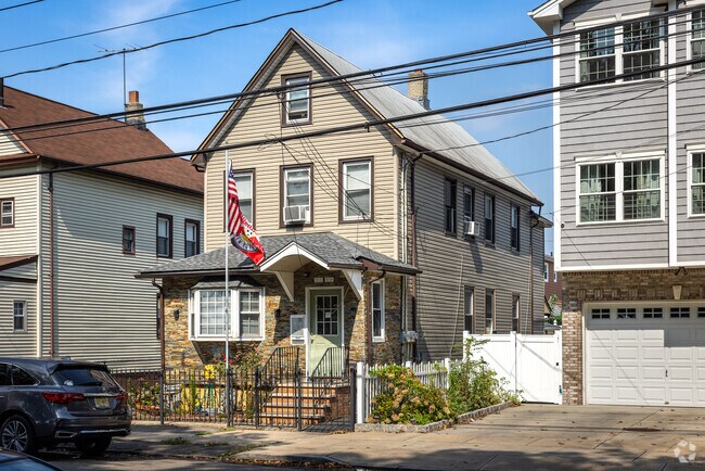 A fine example of a Colonial home in Bayway with US and local sports team flags.