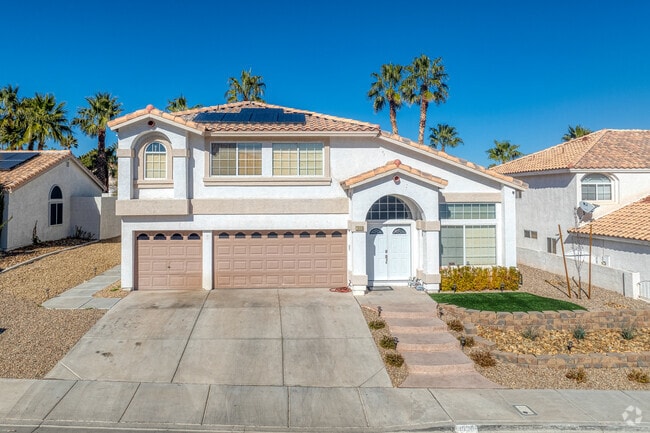 A Two Story Spanish Style Home with Desert landscaping in Whitney Ranch.