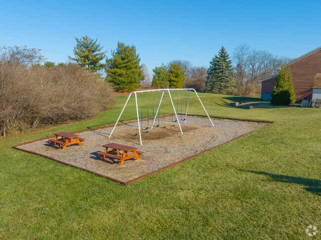 Students enjoy swinging on the swing sets during recess.