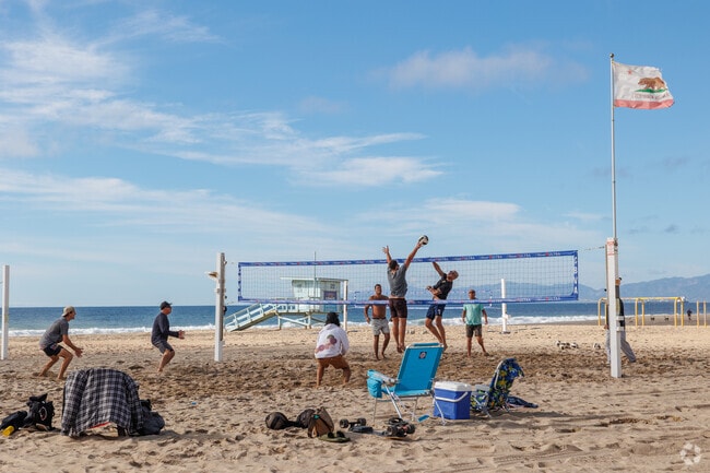 Play volleyball with friends at one of the many courts in Hermosa Beach, CA.